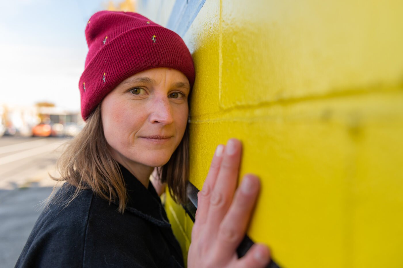 anika-cheek-on-yellow-wall-closeup